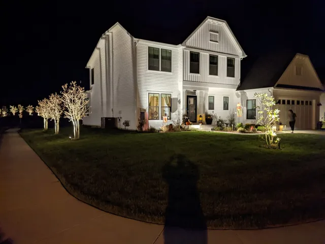 Color-changing landscape lighting in red for a holiday display